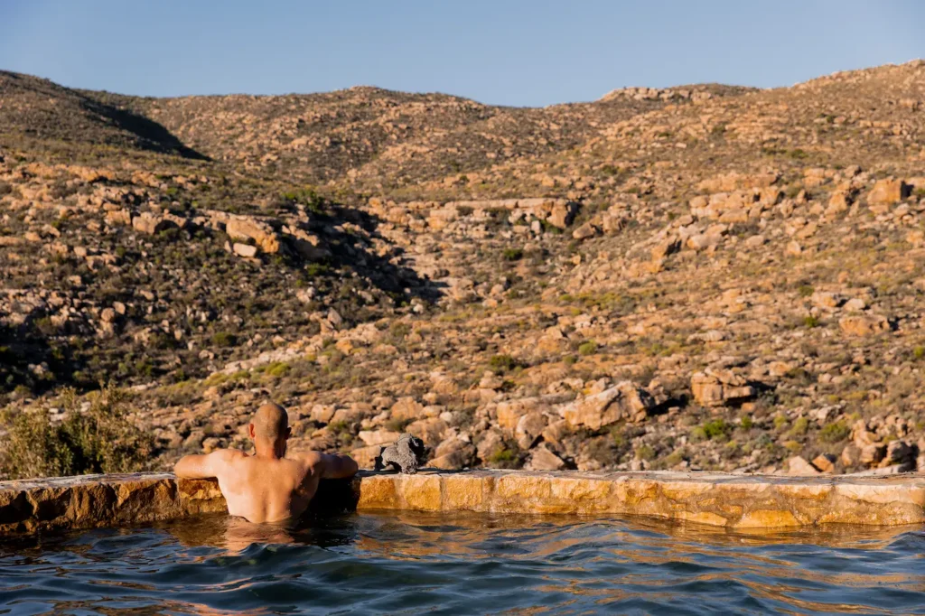 Guest resting in the rock pool looking out over the Cederberg mountains, Bliss and Stars retreat