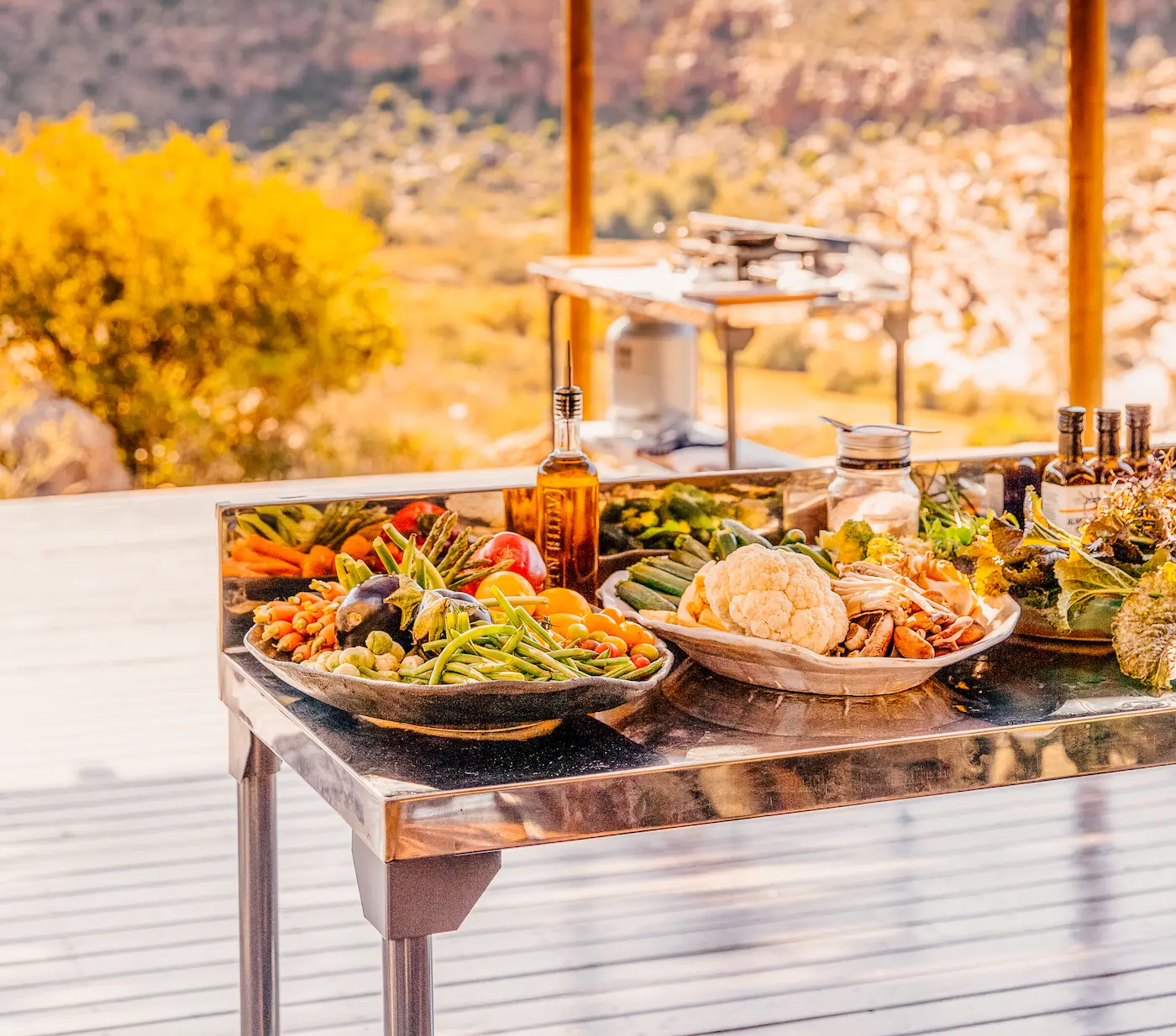 Outdoor kitchen bench laid with fresh vegetables overlooking the Cederberg Mountains, Bliss and Stars retreat