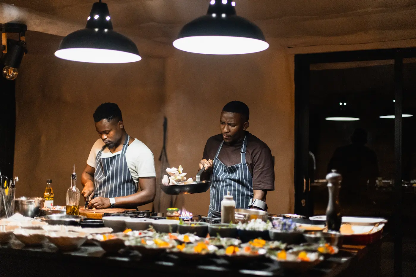 Two chefs preparing plant-based dishes in the Bliss & Stars kitchen, Cederberg